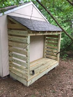 a small wooden outhouse in the woods