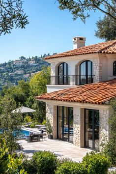 a large house with an outdoor patio and swimming pool