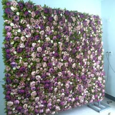 a large purple and white flowered wall in an office building, with the flowers on it's side