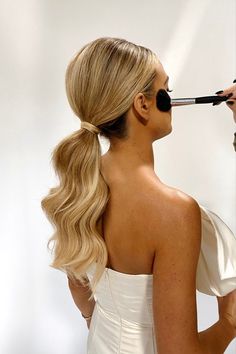 10 Sophisticated Ways To Style Straight Hair for Your Wedding Glam Wedding Ponytail, Slicked Back Wedding Ponytail, Slick Ponytail For Wedding, Bridesmaid Hairstyles Glam Waves, Hollywood Wave Low Ponytail, Long Curly Ponytail Wedding, Formal Hairstyles Low Ponytail, Hollywood Ponytail Wedding, Long Curled Ponytail Wedding