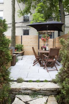 an outdoor dining area with table, chairs and umbrella