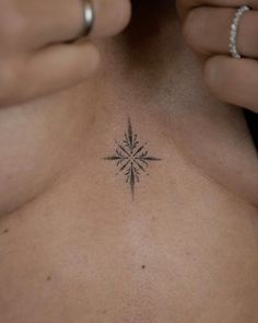 a woman's chest with a small tattoo design on her left side ribcage