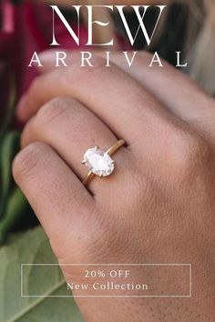 a woman's hand with a ring on it that says new arrival 20 % off new collection