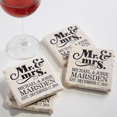 three personalized coasters next to a glass of wine