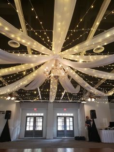 the ceiling is decorated with lights and draping