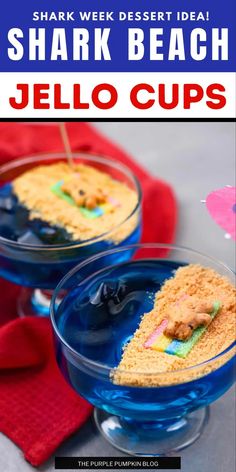 two glasses filled with shark desserts on top of a blue plate and red napkin