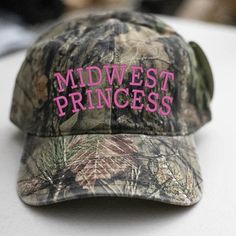 Midwest Princess Embroidered Hat Embroidery is appx 4.5"x 2" 100% Cotton Unstructured Soft Front Low-Fitting 6 Panel Cap Seamed Front Panel 6 Sewn Eyelets Matching Sweatband Adjustable Hook & Loop Closure Size:OSFM Princess Hat, Trucker Humor, Camo Hat, Mossy Oak Camo, Camo Hats, 6 Panel Cap, Hat Embroidery, Embroidered Hat, Princess Aesthetic