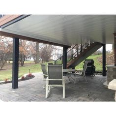 a covered patio area with chairs and tables