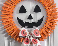 a halloween wreath made out of orange sticks