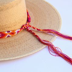 These Beautiful hat bands are carefully hand woven by Rosa in Chiapas,Mexico. Each band showcases a unique and colorful patterned design using traditional macrame techniques. Add a touch of handmade artistry to your hat collection today! Width 1” Length: 23 inches, not including fringe Fringe 9” each side , for an adjustable fit. Fits most hats Polyester yarn All items are shipped from US. All Mi Mundo Mexicano items are 100% handmade by artisans in Mexico. Each stitch and item is completely uni Multicolor Flat Brim Panama Hat For Festival, Adjustable Handwoven Straw Fedora Hat, Adjustable Braided Toquilla Straw Hat, Artisan Adjustable Panama Hat For Vacation, Bohemian Wide Brim Hat For Cinco De Mayo, Adjustable Straw Hat For Beach And Cinco De Mayo, Traditional Hat For Beach And Cinco De Mayo, Adjustable Multicolor Toquilla Straw Sun Hat, Multicolor Toquilla Straw Sun Hat For Festivals