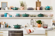 a kitchen filled with lots of pots and pans next to a dishwasher