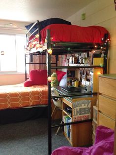 a bunk bed sitting next to a desk in a bedroom