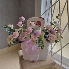 a bag with flowers in it sitting on a chair