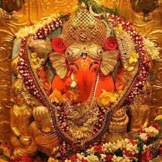 the statue of lord ganesh is surrounded by flowers