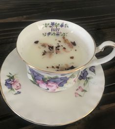 a tea cup filled with milk sitting on top of a saucer