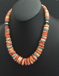 sterling silver orange spiny oyster bead necklace. The necklace measures 20 inch. Orange Sterling Silver Jewelry With Round Beads, Handmade Southwestern Orange Necklace, Handmade Orange Southwestern Necklace, Southwestern Orange Beaded Necklaces With Round Beads, Southwestern Orange Beaded Necklace With Round Beads, Southwestern Orange Round Bead Necklaces, Southwestern Orange Round Beads Jewelry, Southwestern Orange Round Bead Jewelry, Southwestern Orange Round Beads Necklace