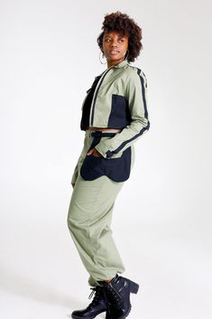 "Let them catch your vibe wearing this edgy pant set with matching jacket. This combo is crafted with cotton, mixed with denim, and designed with three pockets on the jacket, and three pockets on the pants, Cargo style! The jackets design is color blocked for that edginess it brings and the pants has a unique outer pocket on the left front and a half belt closure. Pair up this outfit with a cute bandeau top, or bodysuit and combat boots, Make all your friends wish they had this set too. All of o Sporty Cotton Parachute Pants For Work, Fitted Cotton Utility Jacket For Streetwear, Fitted Cotton Utility Parachute Pants, Sporty Cotton Track Jacket For Work, Winter Cotton Parachute Pants With Hip Pockets, Cotton Track Jacket With Pockets For Work, Fitted Cotton Parachute Pants For Fall, Fitted Cotton Track Jacket With Pockets, Urban Fitted Track Jacket With Pockets