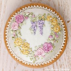 an embroidered heart with pink and yellow flowers