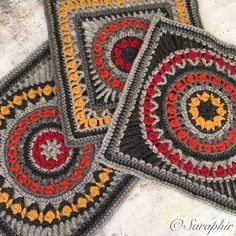 three crocheted coasters are sitting on the floor