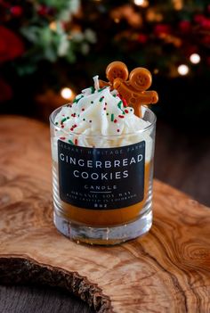 a gingerbread cookie in a glass on top of a wooden table