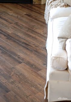 a white couch sitting on top of a wooden floor