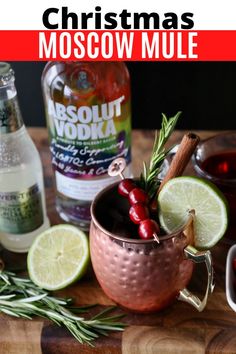 christmas moscow mule recipe in a copper mug garnished with rosemary and lime