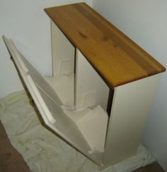 a white refrigerator freezer sitting on top of a wooden counter next to a wall