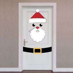 a white door with a santa clause on it's face and a red nose