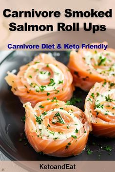 salmon and cream cheese rolls on a black plate with text overlay that reads, cannivor smoked salmon roll ups carnivor diet & keto friendly