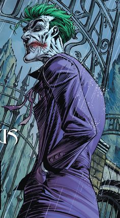 the joker is standing in front of an iron gate with his mouth open and green hair