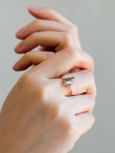 a woman's hand with a diamond ring on it