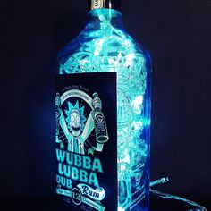 a lit up bottle sitting on top of a table