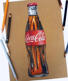 a drawing of a coca - cola bottle on brown paper next to colored pencils