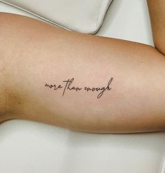 a person with a tattoo on their arm that says, more than enough