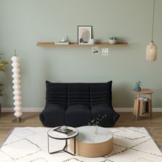 a living room with a white couch and coffee table on top of a shaggy rug