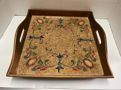 an ornately decorated tray on display in a box