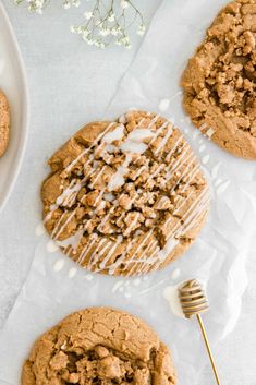 two cookies with icing on top and some spoons next to them