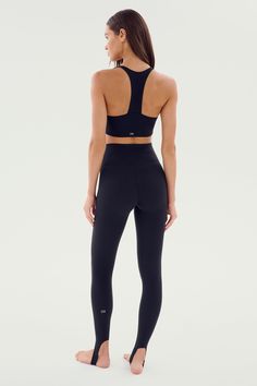 Our famous, form fitting high waist legging redesigned as a stirrup tight. Our ultra luxe Airweight fabric has a supremely soft hand and second skin comfort. BEST FOR: hot yoga, barre, Pilates. Model is 5'10" and wears a size small. Sleek Fitted Training Bottoms, Compressive Tights For Training, Fitted Athleisure Tights With Light Support, Compressive Tights With Contoured Waistband For Pilates, Fitted Light Support Athleisure Tights, Versatile Compressive Tights For Training, Compressive Training Tights, Compressive High Rise Sporty Tights, Fitted High Rise Activewear For Yoga