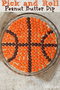 a cake decorated with orange and brown candies in the shape of a basketball ball