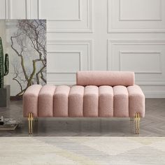 a pink couch sitting on top of a wooden floor