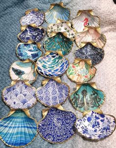 many different types of decorative plates on a blanket