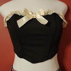 Offered Is A Fantastic Black Bustier With Ivory Double Ruffle Lace And Satin Ribbon Trim. Gummed Top For Non Slip. Flexible Plastic Boning (4). New Without Tags, Made By Shein. Size Small. All Measures Are Approx. Bust 31" Bottom 27" Length Center 10" Length Side 7" Fabric Content: 95% Polyester 05% Elastane P41 Free Crop Tops, Nike Crop Top, Cropped White Tee, Linen Crop Top, Black Bustier, Waffle Knit Top, Lace Crop Tops, Print Crop Tops, Lace Ruffle