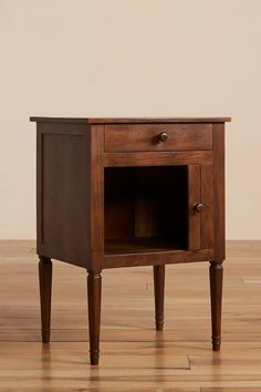 a small wooden table with an open drawer