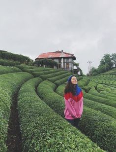 a woman standing in the middle of a maze