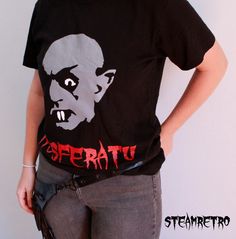 unisex quality cotton Nosferatu inspired vampire t-shirt designed by Steamretro. One of our best selling designs during our gothic festival season! Horror Style Cotton T-shirt With Screen Print, Affordable Black Horror T-shirt, Goth Choker, Horror Graphic Print Short Sleeve T-shirt, Black Horror T-shirt With Skull Print, Black Cotton Horror T-shirt, Gothic Chokers, Festival T Shirts, Steampunk Earrings