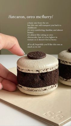 a person touching an oreo sandwich on top of a cookie sheet with the caption fatcoon, oreo mcclurry