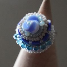 When I make a ring, I first decide on the main bead. If the beads are embroidered in a way that enhances them, the result is a ring that is colorful and lively, almost as if it is talking. If you wear such a ring when you go out, you will be able to spread the chatter even further. and the chatter will spread even more. This is a chatty ring made with the hope that this will happen. Size of the decorative part: about 1 in (2.5 cm) in diameter Size of the ring: free (you can adjust it by yourself Handmade Multicolor Bohemian Crystal Ring, Handmade Adjustable Multicolor Crystal Ring, Handmade Unique Crystal Open Ring, Multicolor Handmade Open Ring, Unique Handmade Ring As A Gift, Unique Handmade Ring As Gift, Unique Blue Flower Ring For Gift, Handmade Blue Bohemian Crystal Ring, Blue Flower Ring For Gift