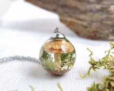 You certainly know that no two nature elements are alike. Therefore, this mushroom necklace resin necklace is made just for you; a terrarium necklace pendant from my real mushroom jewelry. Make this dried flower necklace the perfect complement you've always been looking for. Or make this mushroom necklace resin necklace the perfect gift for her. Combine this terrarium necklace pendant with your favorite colors; wear this dried flower necklace with your most original or casual clothes. Either way Nature-inspired Resin Jewelry As Gift, Nature-inspired Pressed Flowers Necklace Gift, Nature-inspired Necklaces With Pressed Flowers, Nature-inspired Round Resin Necklace, Nature-inspired Resin Round Pendant Jewelry, Nature-inspired Round Resin Pendant Jewelry, Nature-inspired Resin Round Pendant Necklace, Nature-inspired Resin Round Pendant Necklaces, Nature-inspired Resin Necklaces With Round Pendant