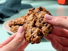 a person holding a cookie in their hand