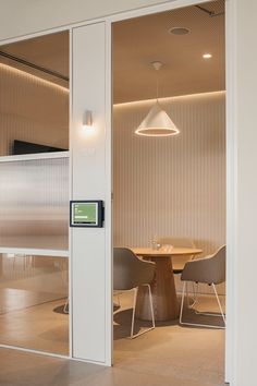 an office meeting room with sliding glass doors